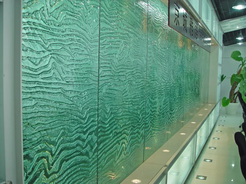 Green cast glass wall with layered textured relief in a showroom interior